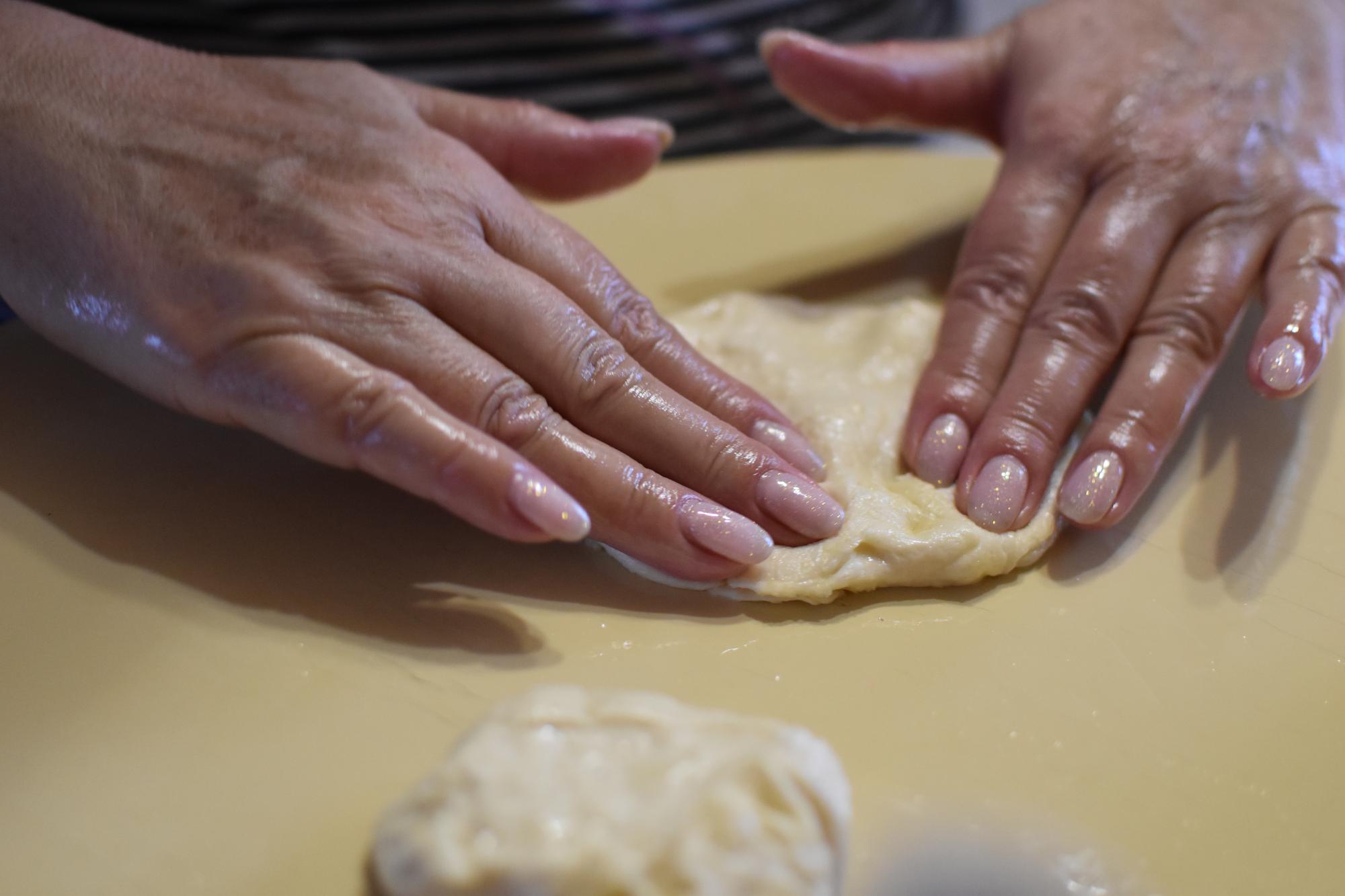 Close-up of hands kneading dough
